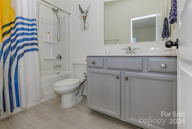 full bathroom with shower / bathtub combination with curtain, vanity, and toilet