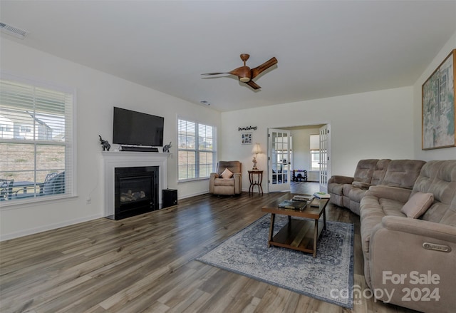 living room with hardwood / wood-style flooring and ceiling fan