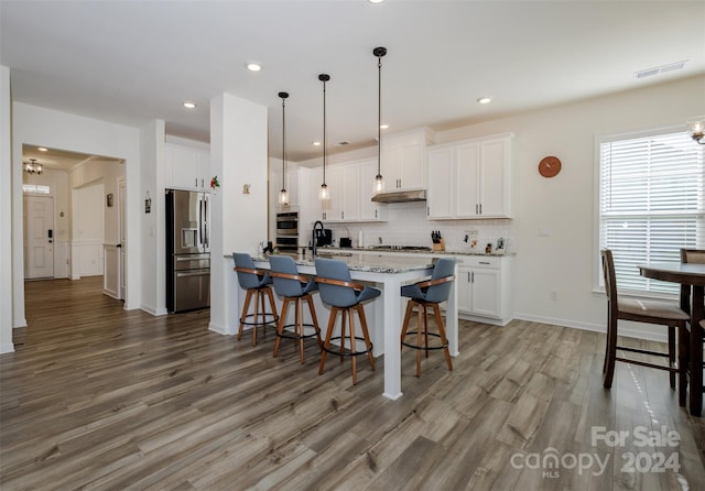 kitchen featuring white cabinetry, an island with sink, and appliances with stainless steel finishes