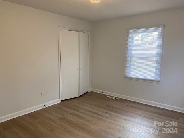 unfurnished room featuring dark wood-type flooring