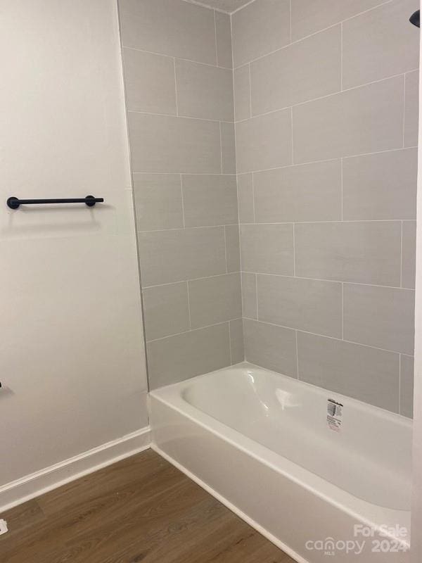 bathroom featuring hardwood / wood-style floors and tiled shower / bath