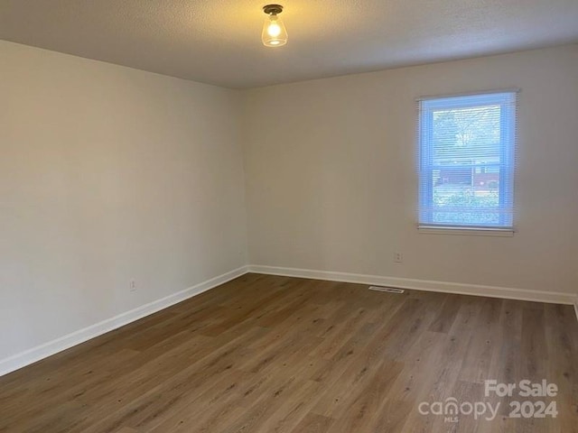 spare room featuring dark hardwood / wood-style floors