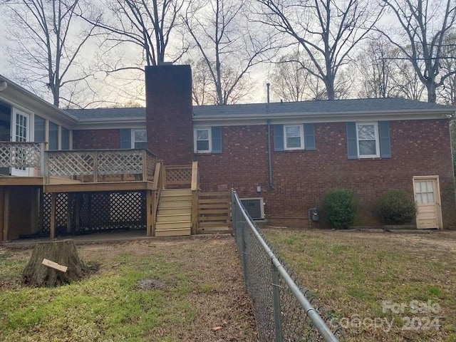 back of property featuring a deck