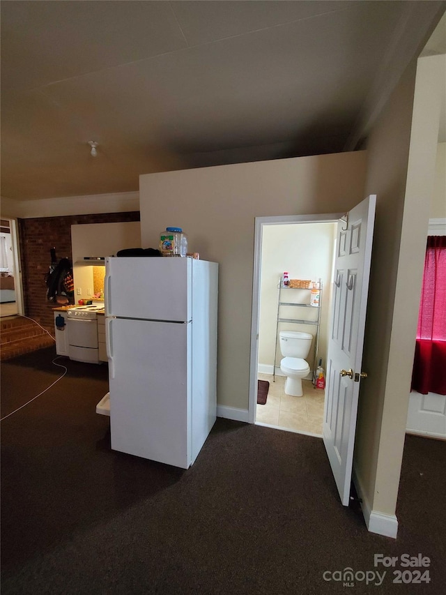 interior space featuring carpet flooring and white refrigerator