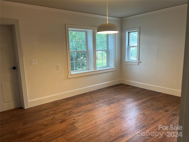 spare room with dark wood-type flooring and ornamental molding