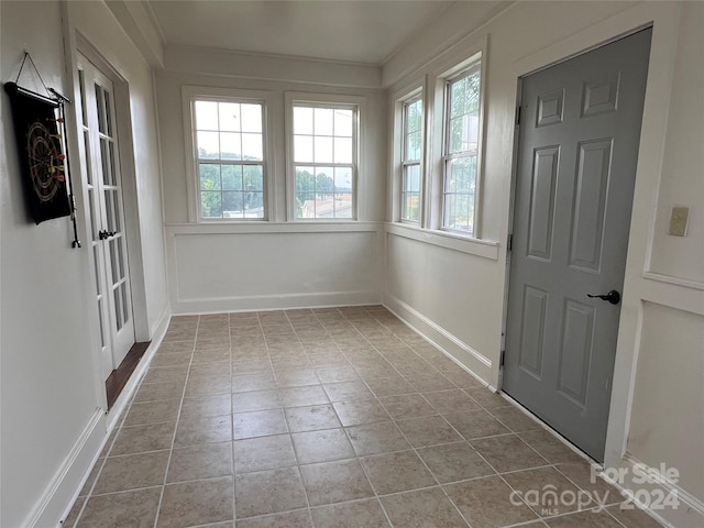 unfurnished sunroom featuring plenty of natural light