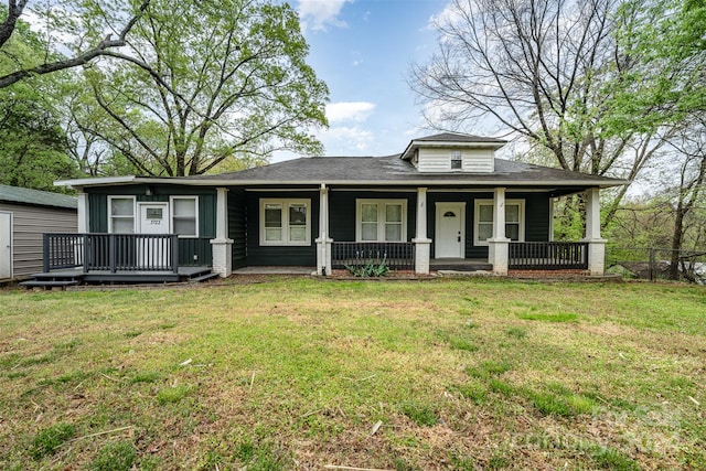 view of front of house with covered porch and a front yard