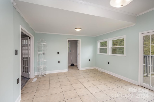 unfurnished room featuring ornamental molding and light tile floors