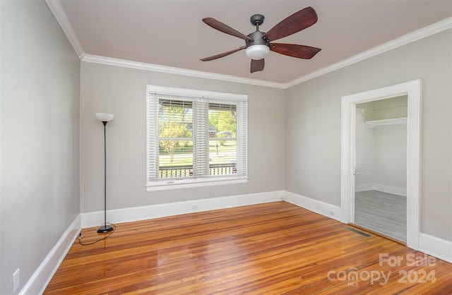 spare room with hardwood / wood-style floors, ceiling fan, and ornamental molding