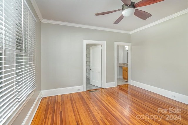 spare room featuring ornamental molding, ceiling fan, and light wood-type flooring