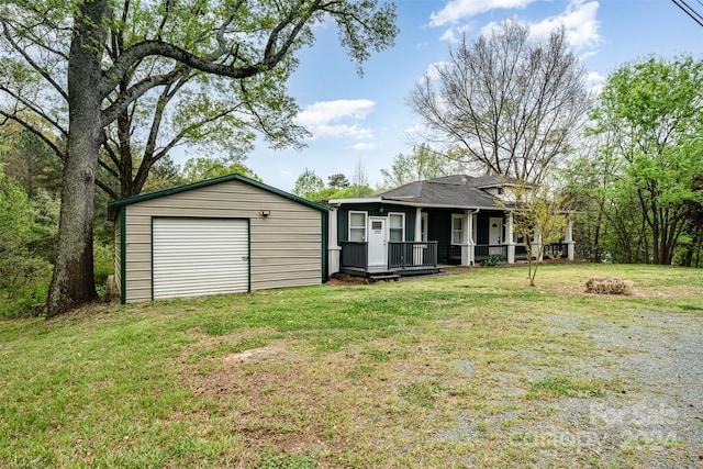 view of front of property with a garage, an outdoor structure, and a front lawn