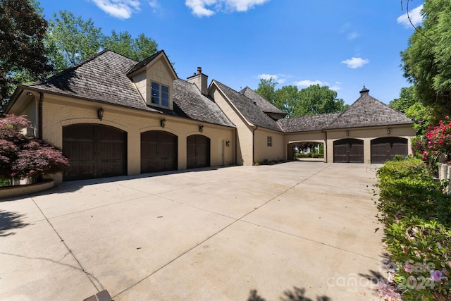 french country style house featuring a garage