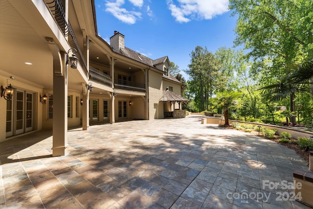 view of patio with french doors and a balcony