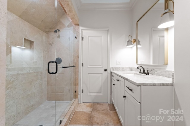 bathroom featuring ornamental molding, walk in shower, vanity with extensive cabinet space, and tile floors