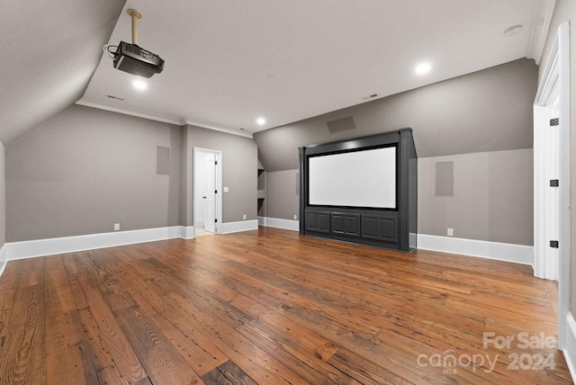 cinema featuring lofted ceiling and hardwood / wood-style floors