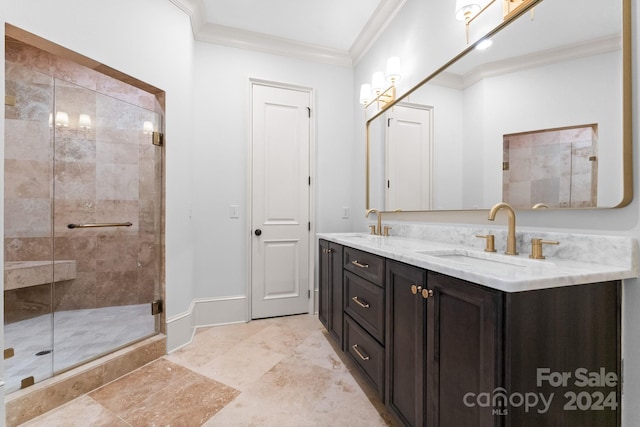 bathroom featuring a shower with shower door, dual bowl vanity, tile floors, and ornamental molding