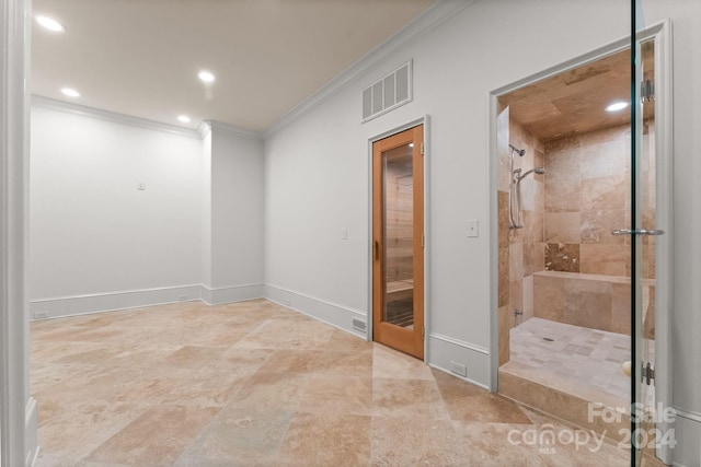 bathroom with crown molding, tile flooring, and a tile shower