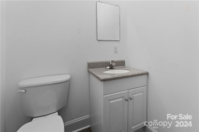 bathroom featuring large vanity and toilet