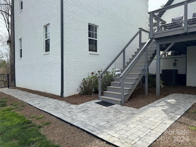 exterior space featuring a deck, central AC unit, and a patio