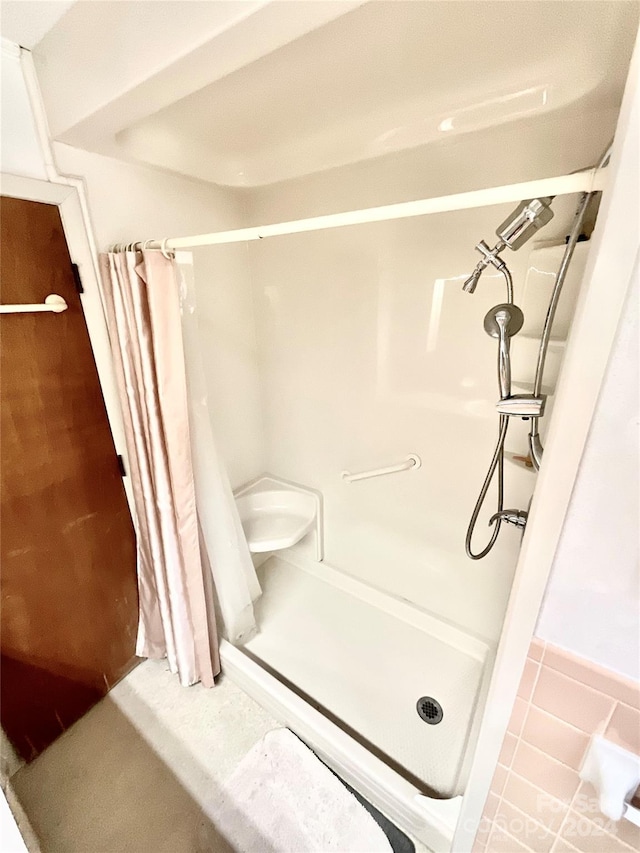 bathroom featuring walk in shower and tile flooring