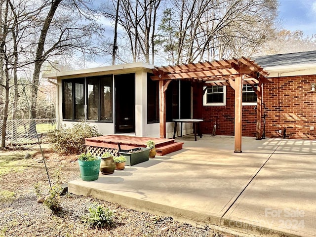 rear view of house featuring a pergola and a patio area