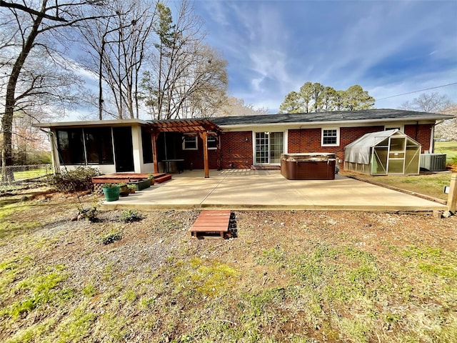 rear view of property featuring central AC, a patio area, and a hot tub