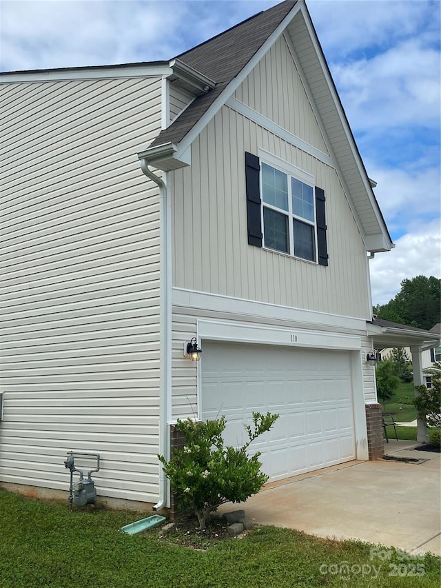 view of home's exterior featuring a garage and roof with shingles