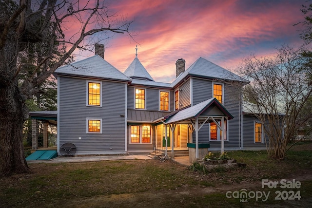 view of back house at dusk