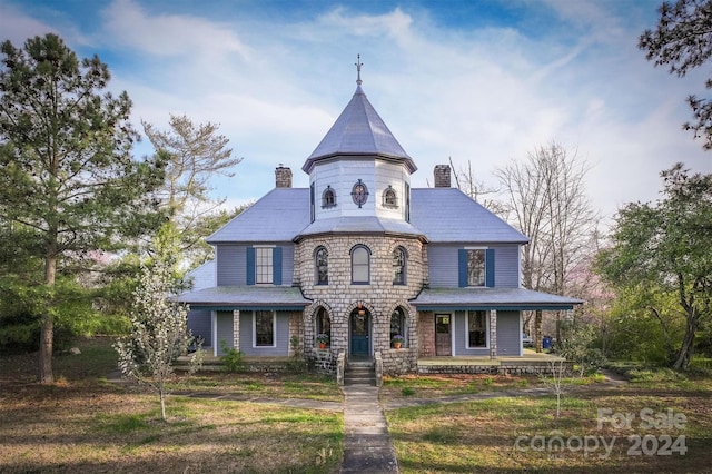 victorian home with a front lawn