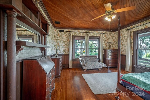 bedroom featuring dark hardwood / wood-style floors, ornamental molding, wooden ceiling, and ceiling fan