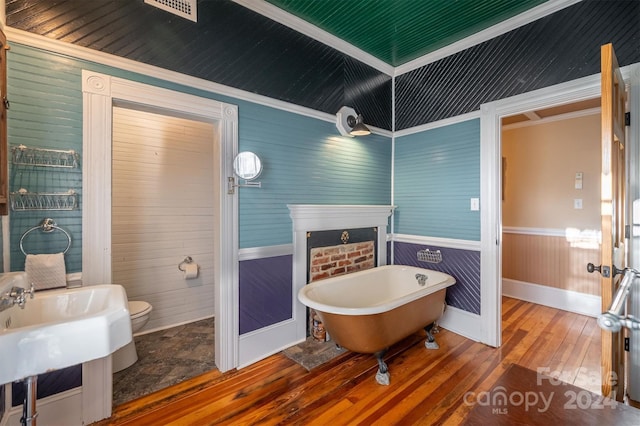 bathroom featuring wooden ceiling, hardwood / wood-style flooring, toilet, a bath, and ornamental molding