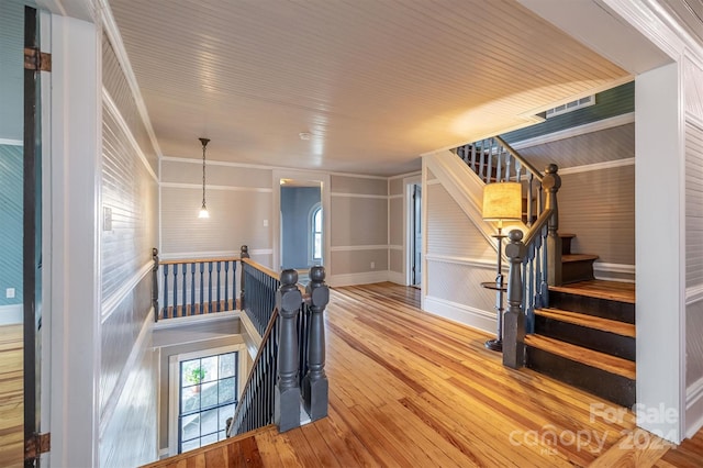 interior space featuring crown molding, wood ceiling, and light hardwood / wood-style flooring