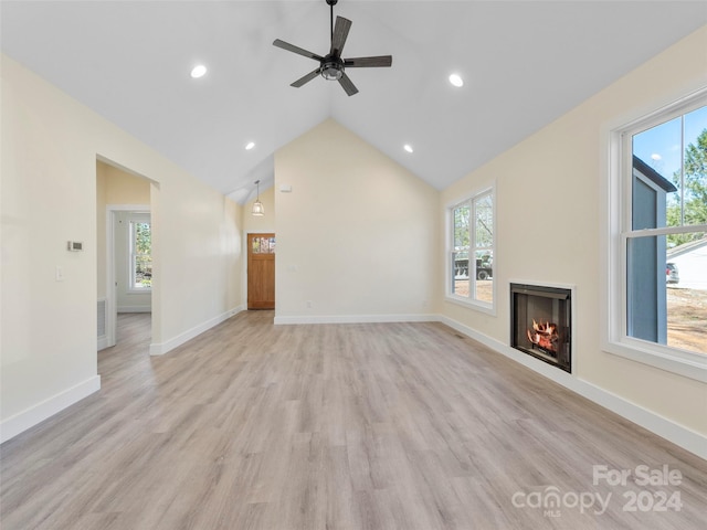 unfurnished living room with ceiling fan, high vaulted ceiling, and light hardwood / wood-style floors