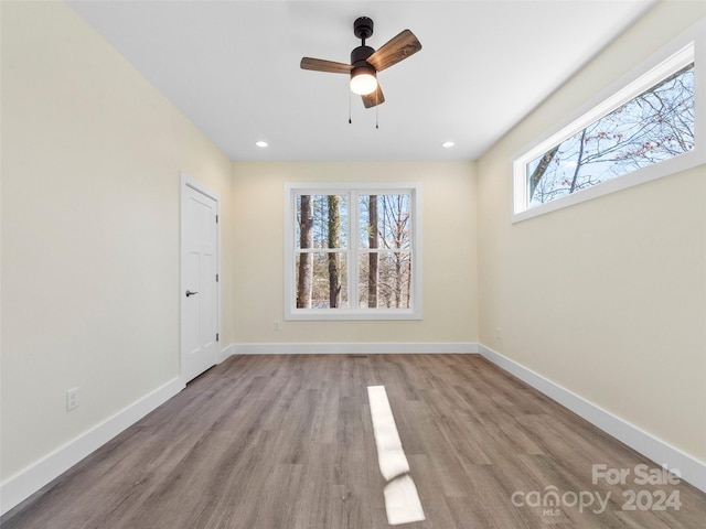 empty room with light hardwood / wood-style flooring and ceiling fan