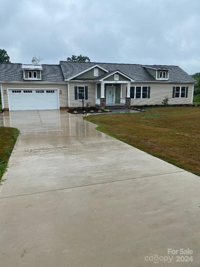 view of front of house featuring a garage and a front lawn