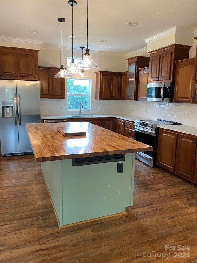 kitchen with a center island, butcher block counters, stainless steel appliances, and dark hardwood / wood-style floors