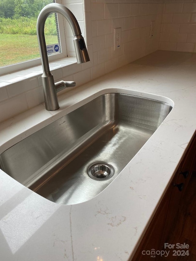 interior details with sink and tasteful backsplash