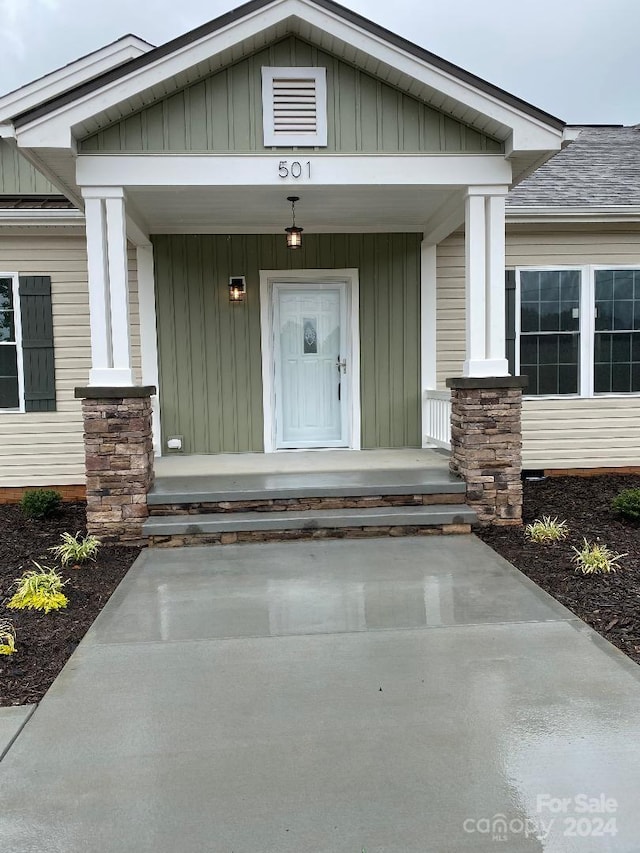 view of exterior entry with a porch