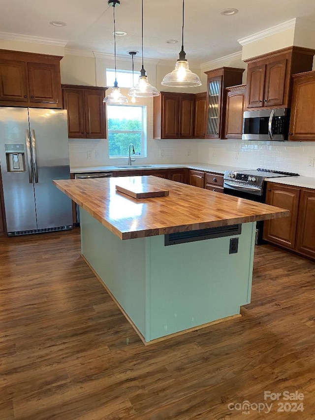 kitchen featuring butcher block countertops, appliances with stainless steel finishes, a center island, and dark hardwood / wood-style floors