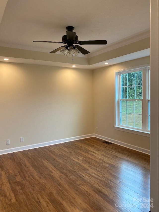 unfurnished room featuring crown molding, ceiling fan, and dark hardwood / wood-style floors