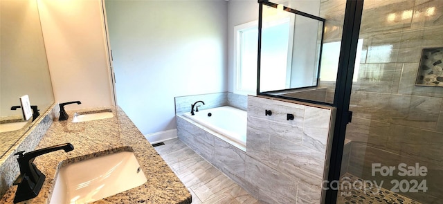 bathroom featuring vanity and separate shower and tub