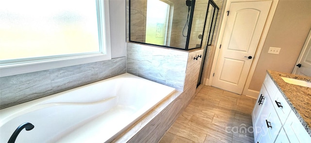 bathroom with vanity and separate shower and tub