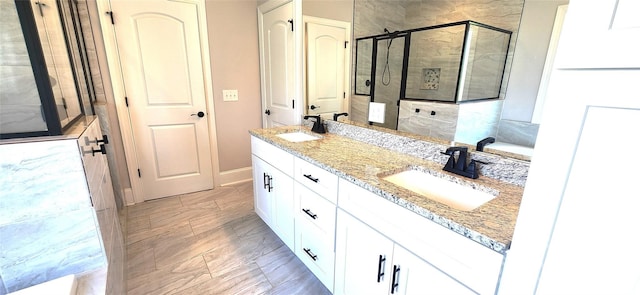 bathroom featuring vanity and a shower with shower door