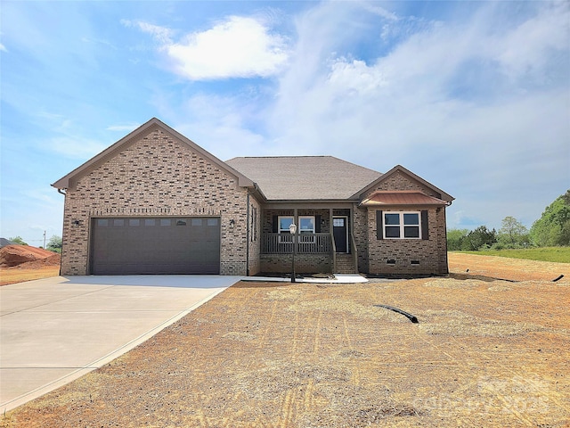 view of front of house with concrete driveway, brick siding, covered porch, and a garage