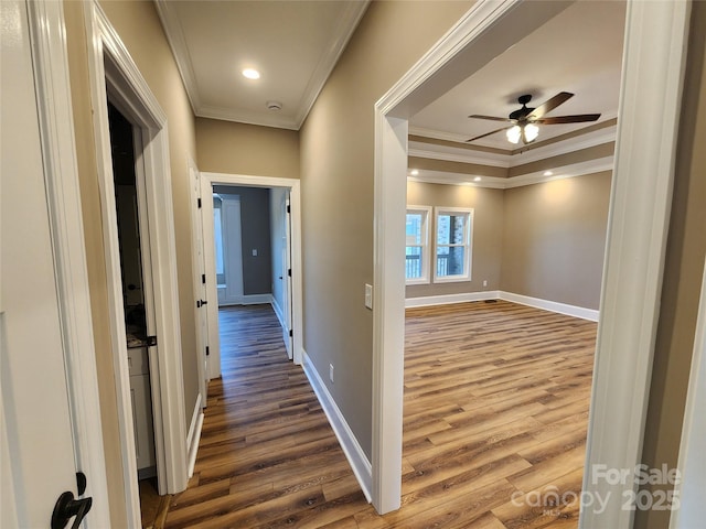 hall with dark wood finished floors, baseboards, crown molding, and recessed lighting