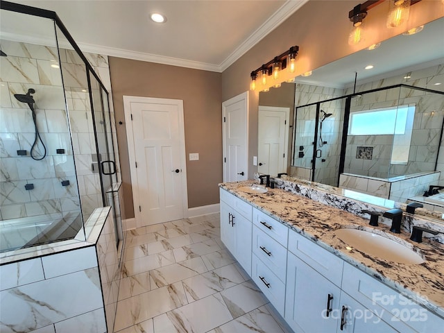 full bath featuring a shower stall, baseboards, ornamental molding, and a sink