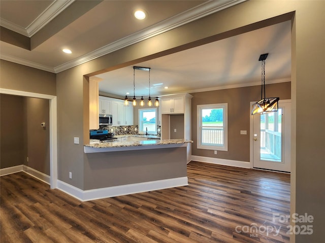 kitchen with white cabinets, stainless steel appliances, baseboards, and dark wood-style floors