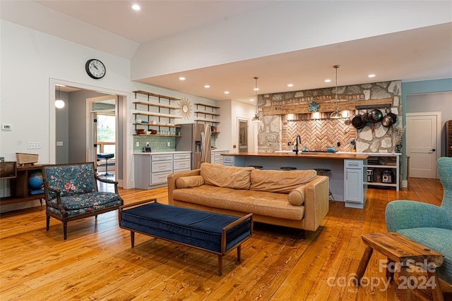 living room with light wood-type flooring and indoor wet bar