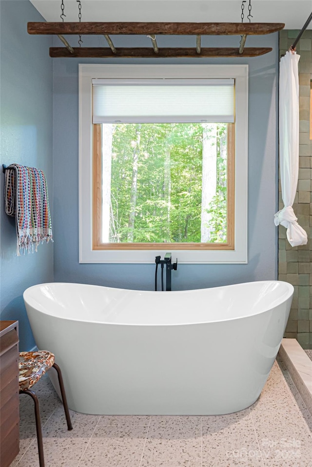 bathroom with tile walls and separate shower and tub