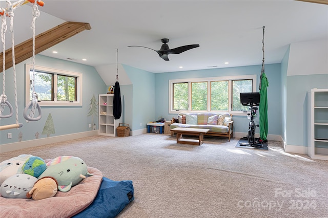 interior space featuring vaulted ceiling, carpet flooring, a healthy amount of sunlight, and ceiling fan